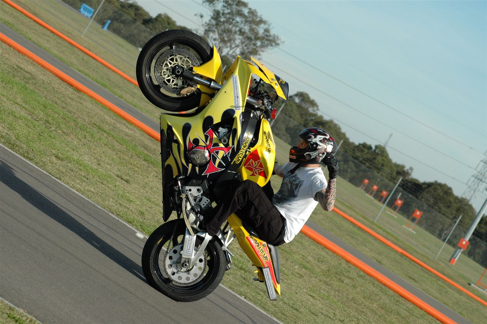 No hands wheelie on a yellow 954